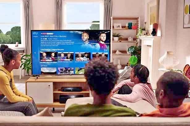 People watching live TV and sports after buying IPTV on a 4K Smart TV at home